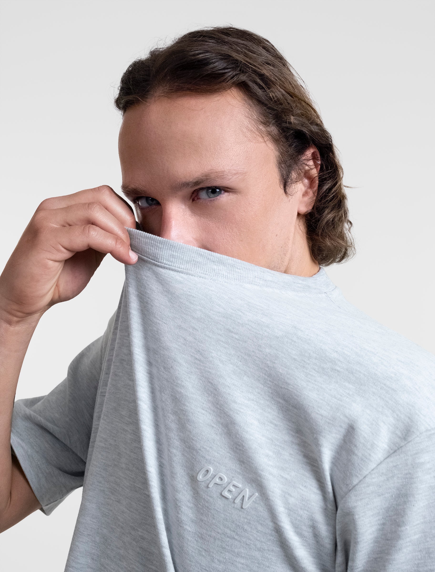 Open Row Men's Open Heart Tee in grey, frontal closeup view, embossed logo detail.