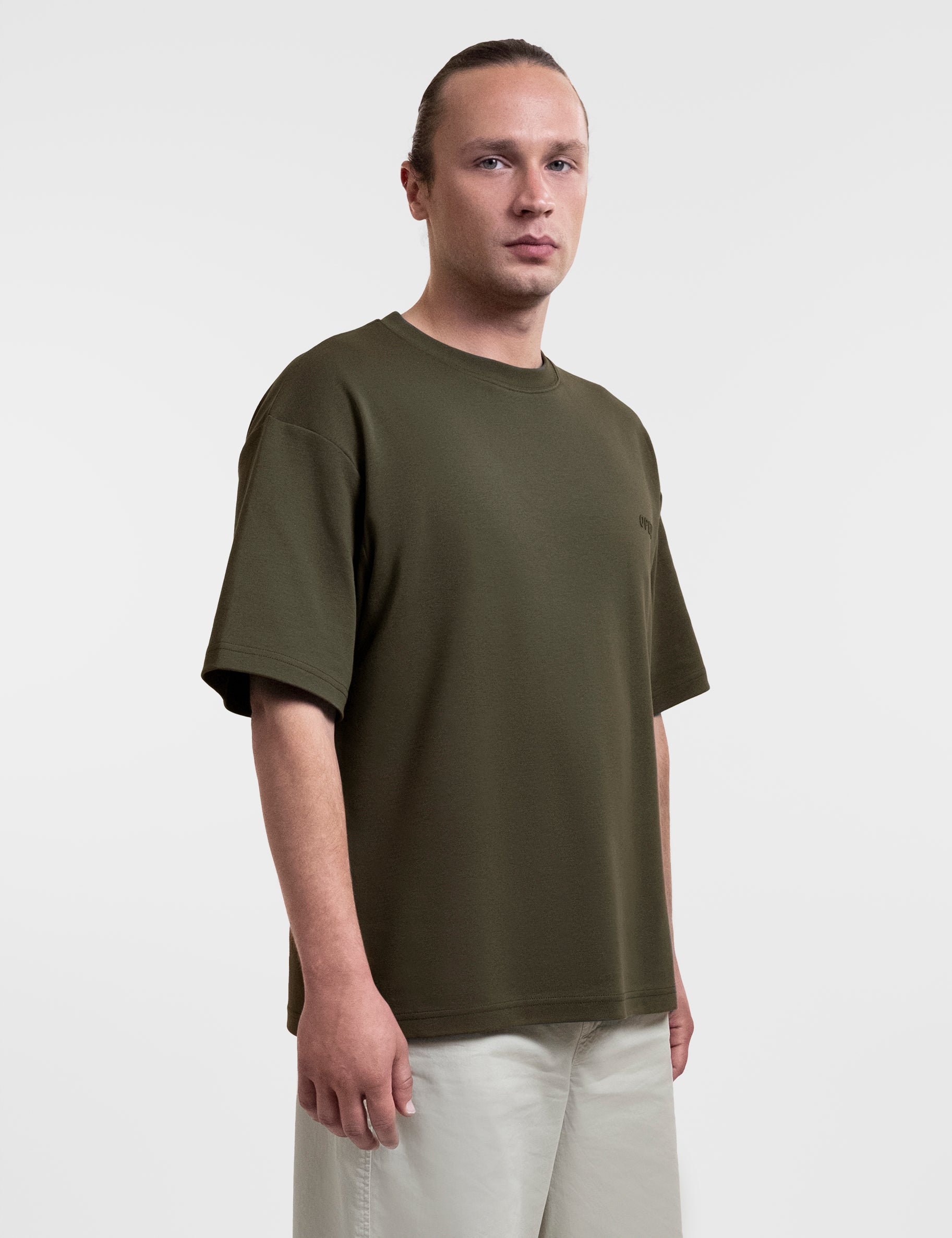 Open Row Men's Open Heart Tee in khaki green, tree-quarter front view.