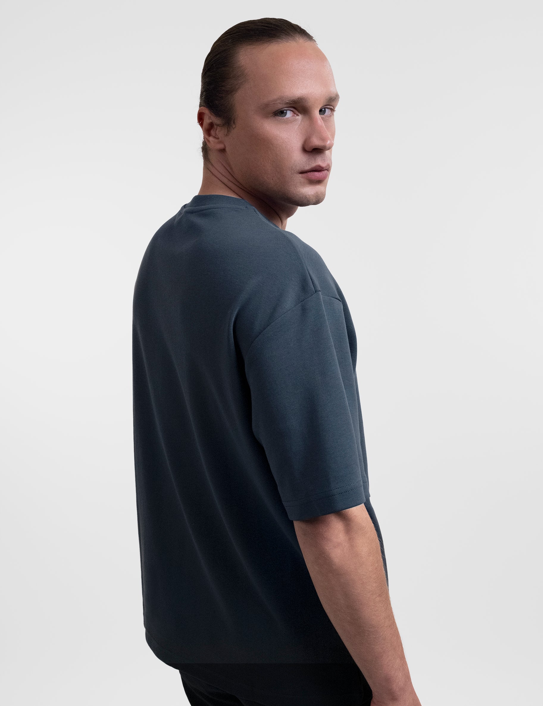 Open Row Men's Open Heart Tee in navy blue, side view.