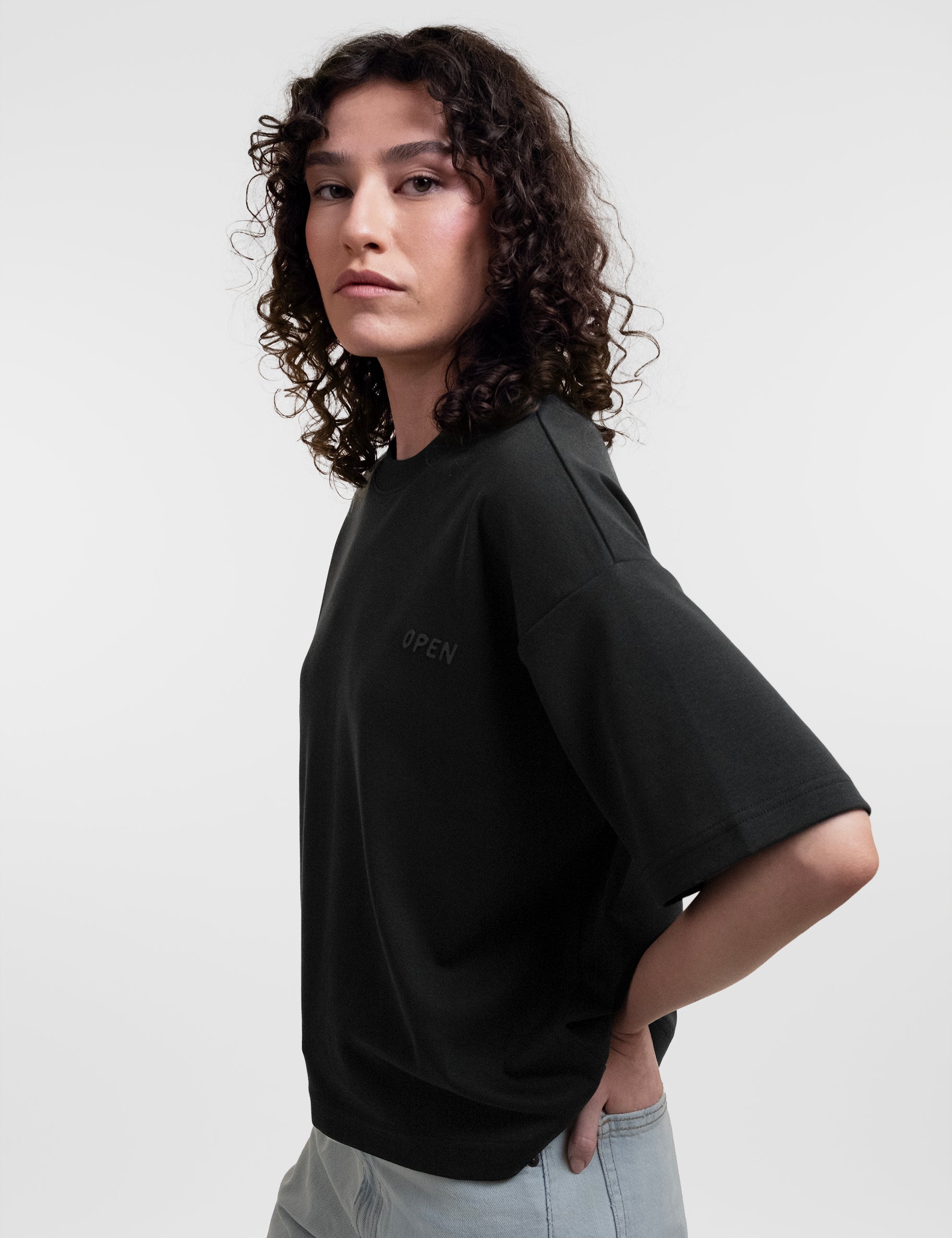 Open Row Women's Open Heart Tee in black, side view.