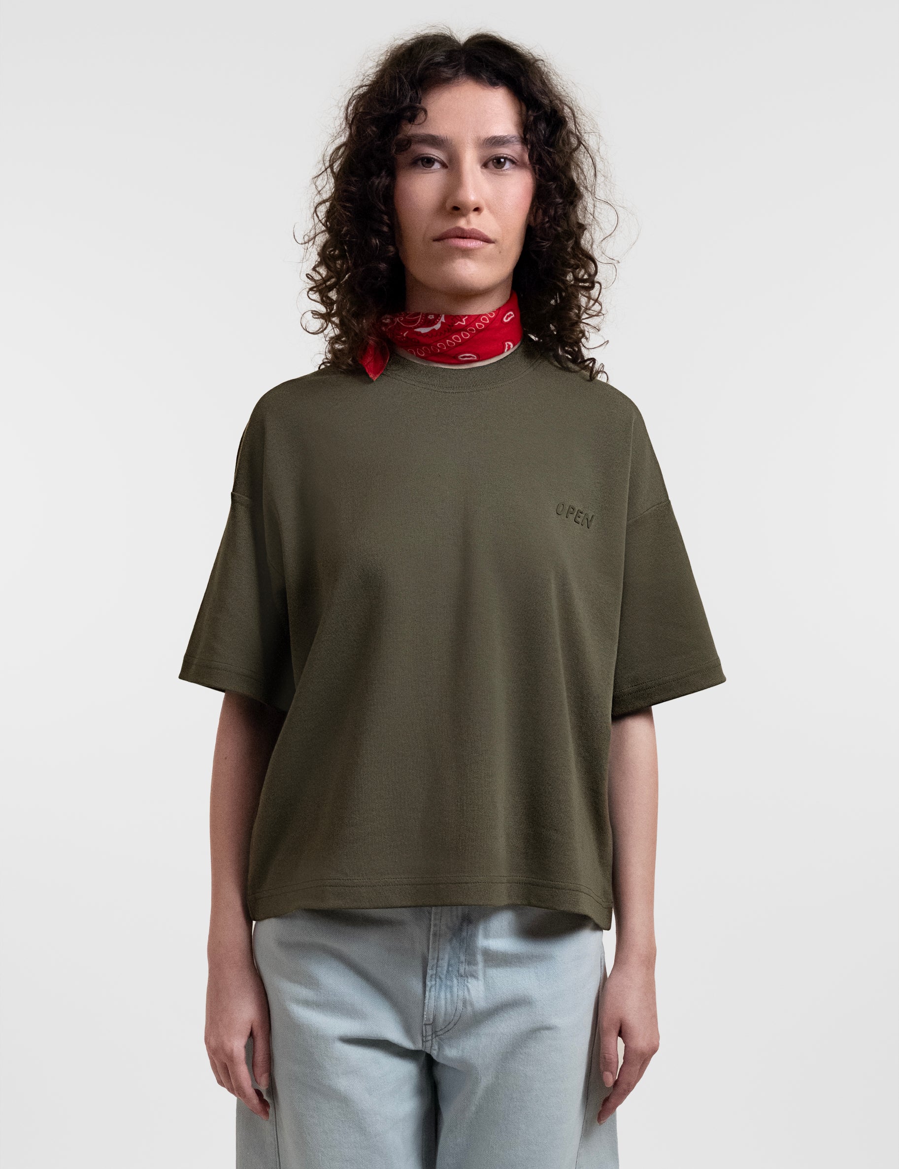 Open Row Women's Open Heart Tee in khaki green, front view paired with a red neck scarf.