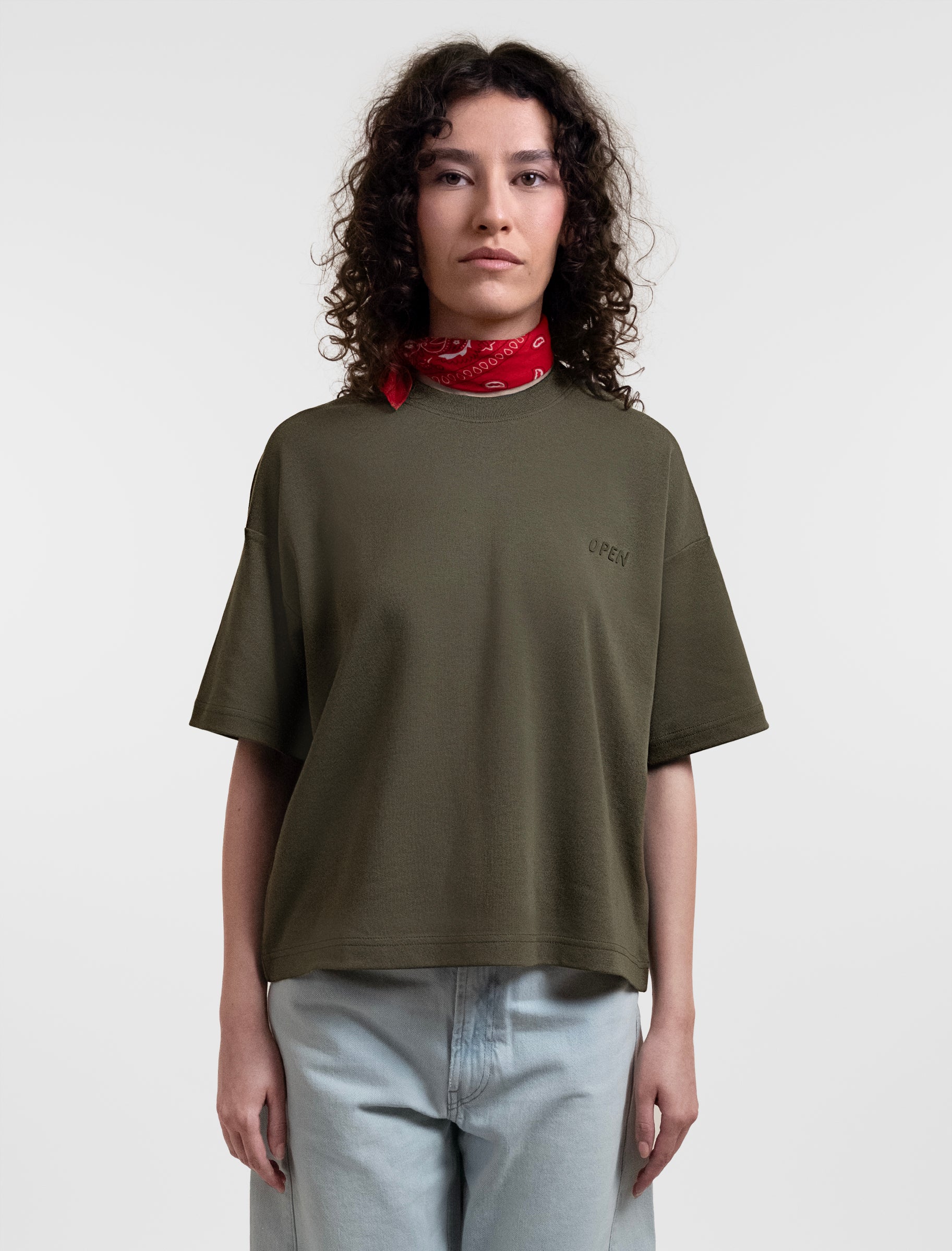 Open Row Women's Open Heart Tee in khaki green, front view paired with a red neck scarf.