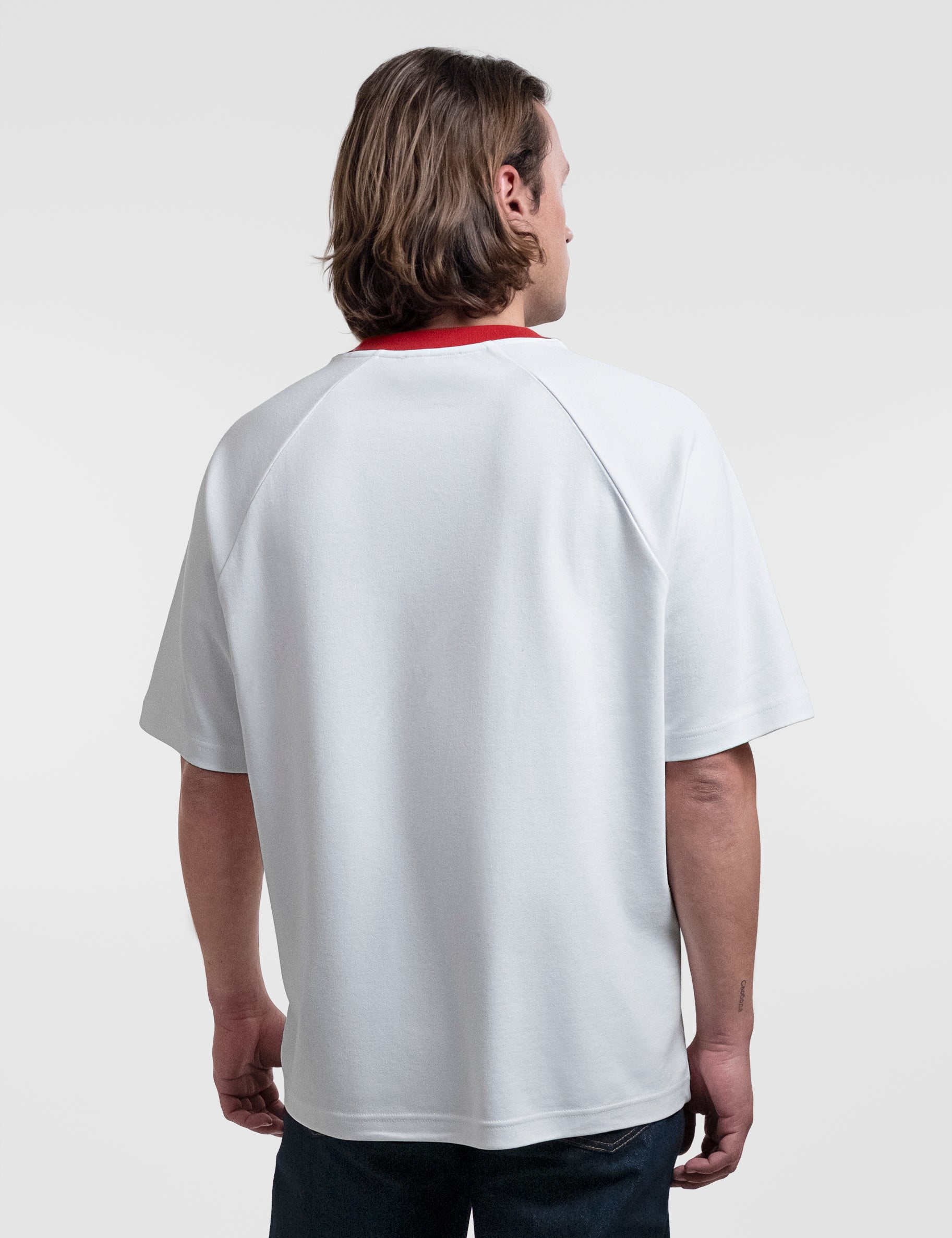 Open Row Men's Runaway Tee in white with red collar, back view.