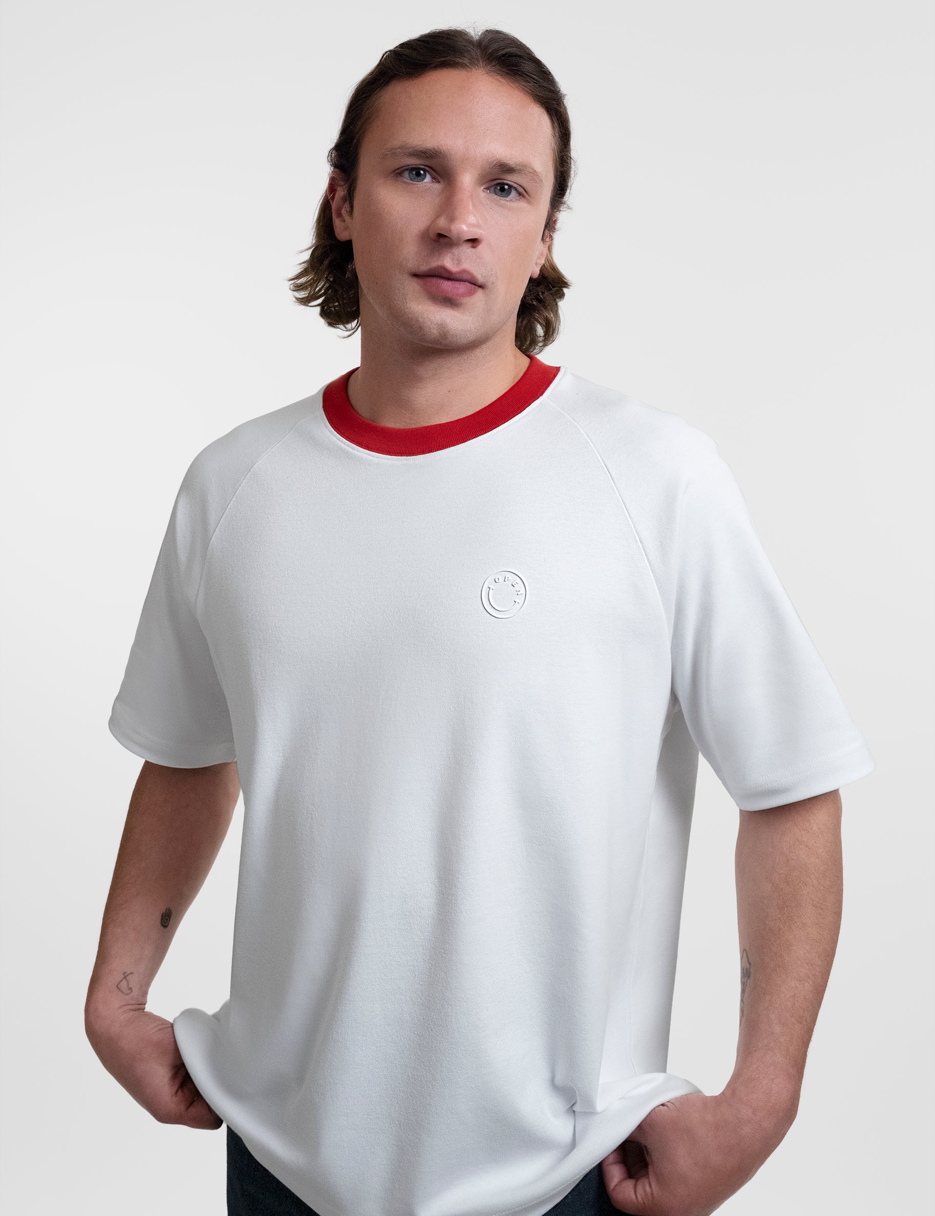 Open Row Men's Runaway Tee in white with red collar, front side view.