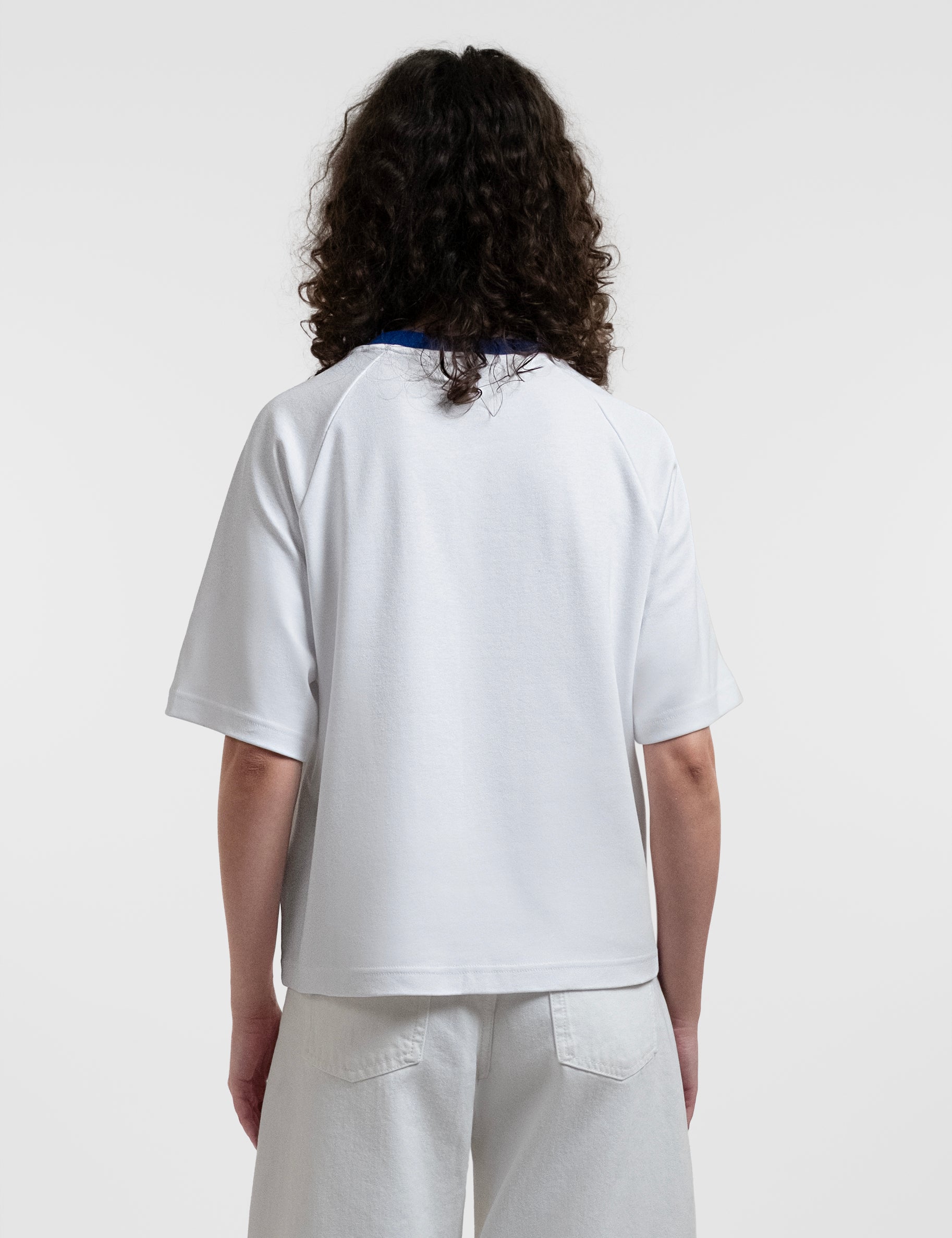 Open Row Women's Runaway Tee in white with blue collar, back view.