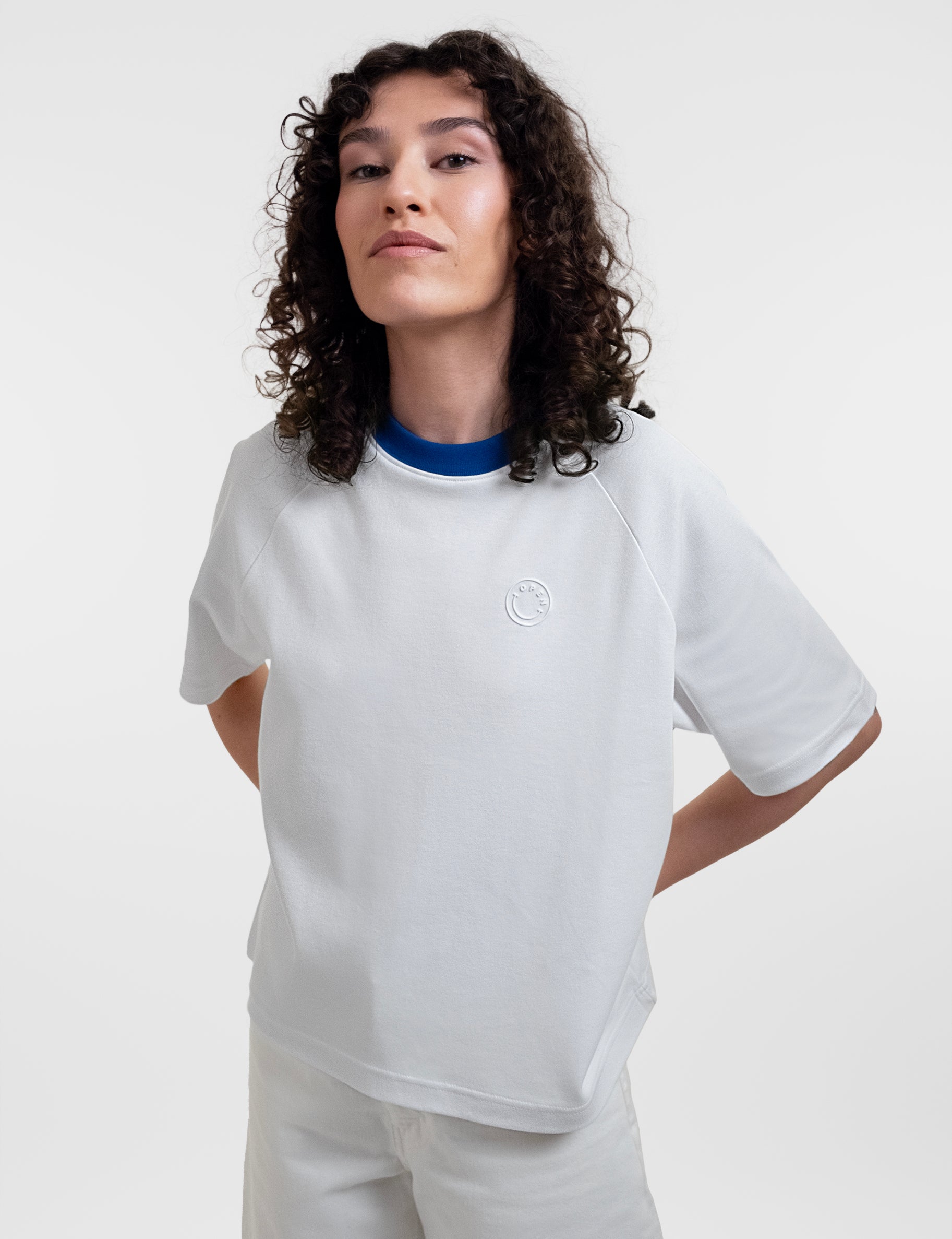 Open Row Women's Runaway Tee in white with blue collar, front editorial view.