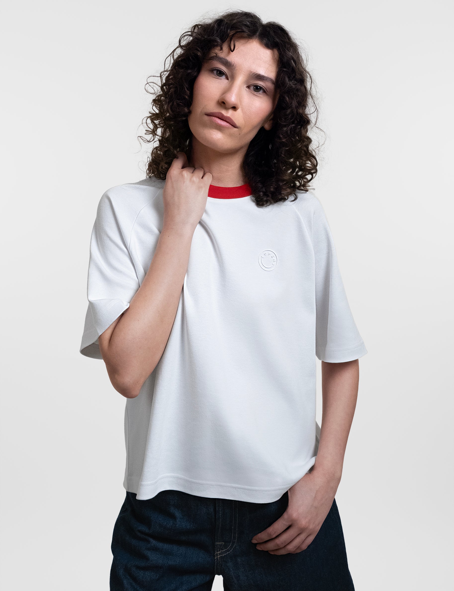 Open Row Women's Runaway Tee in white with red collar, front editorial view.