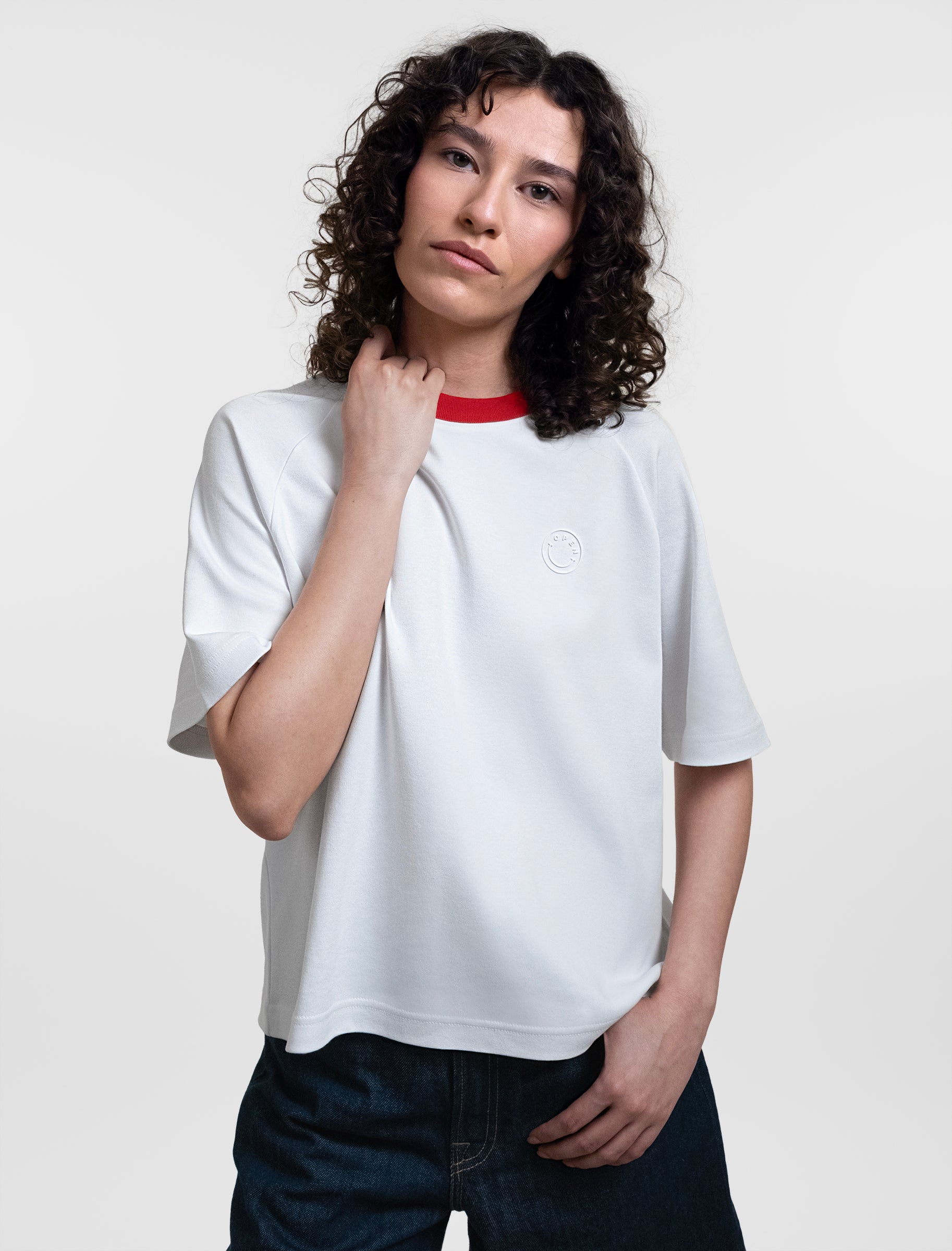 Open Row Women's Runaway Tee in white with red collar, front editorial view.