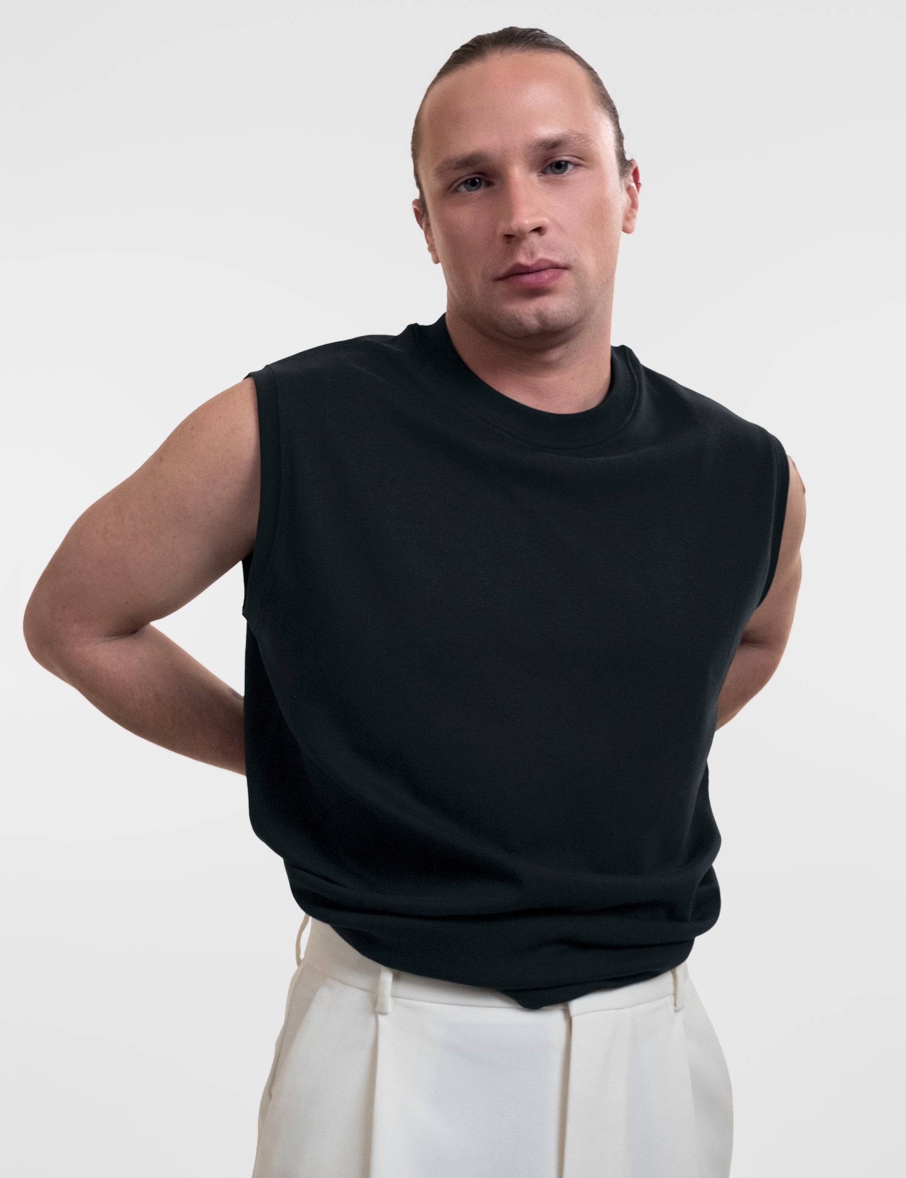Open Row Men's Tank Tee in black, front view showing waistline.