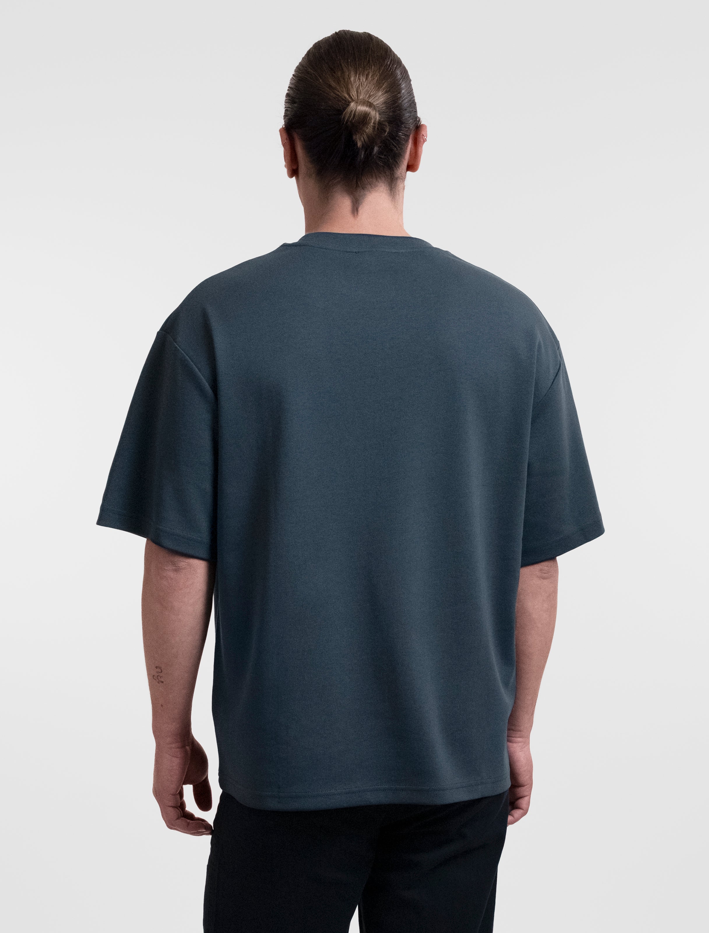 Open Row Open Heart Men's Tee in navy blue, back view.