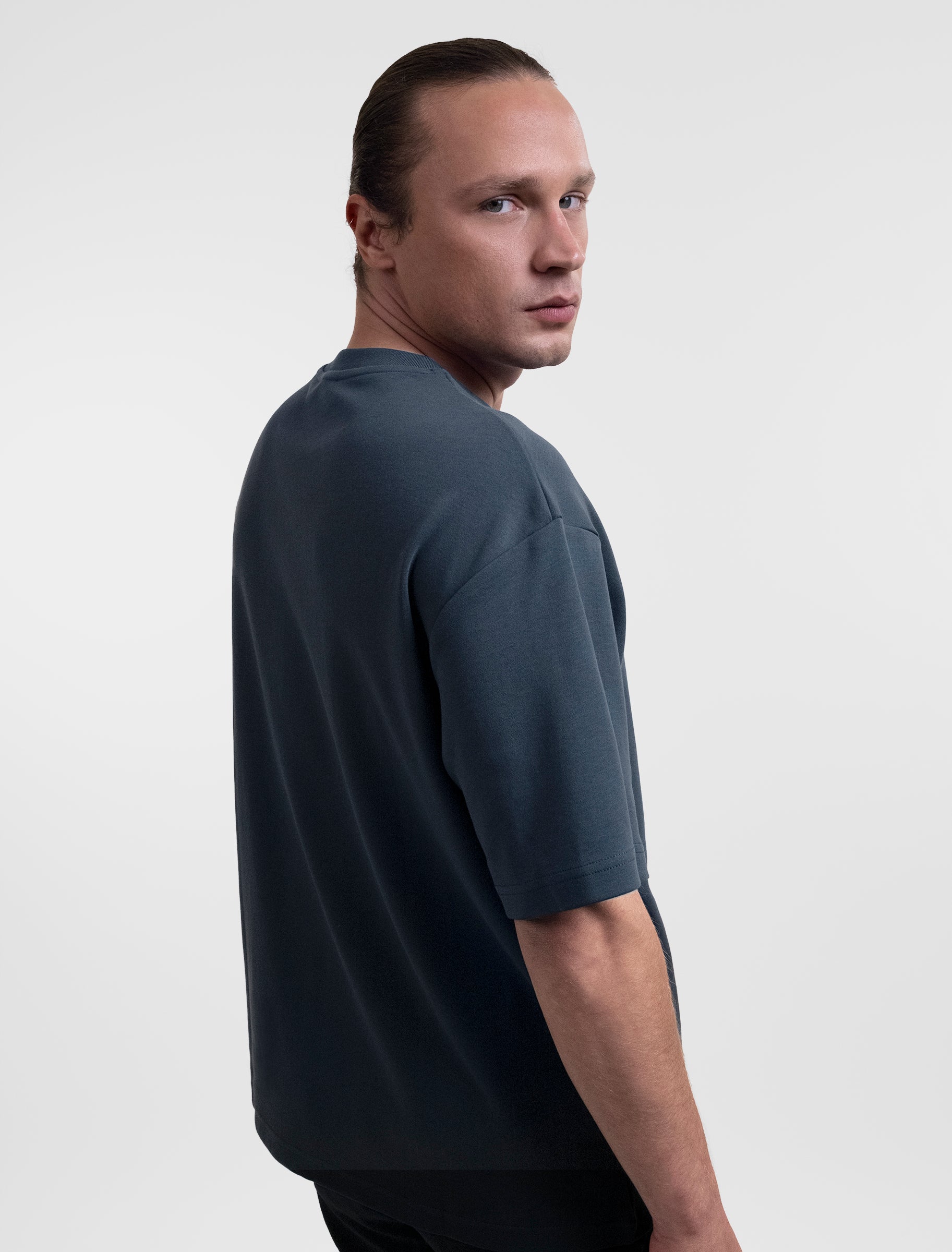 Open Row Men's Open Heart Tee in navy blue, side view.