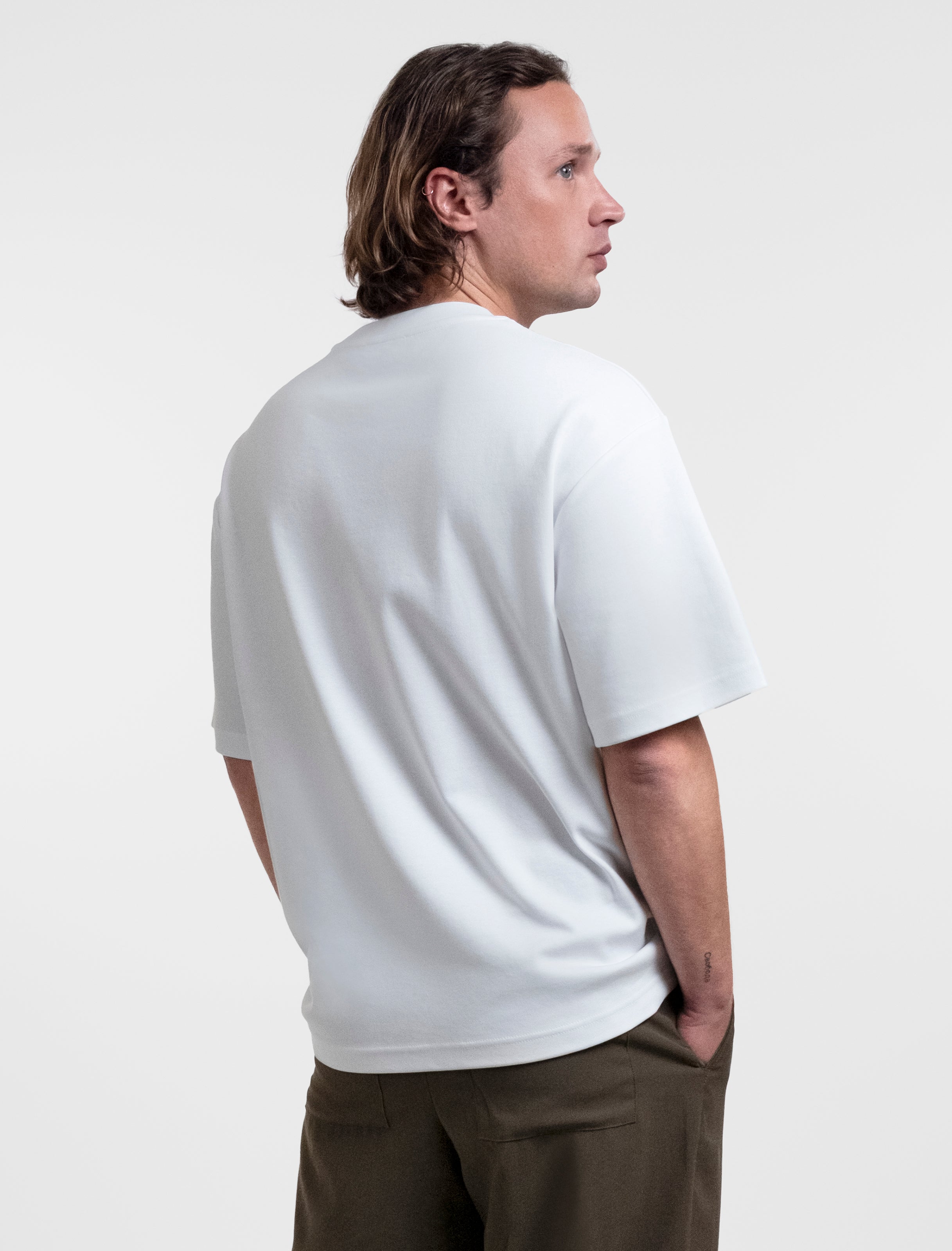 Open Row Men's Open Heart Tee in white, three-quearter back view.