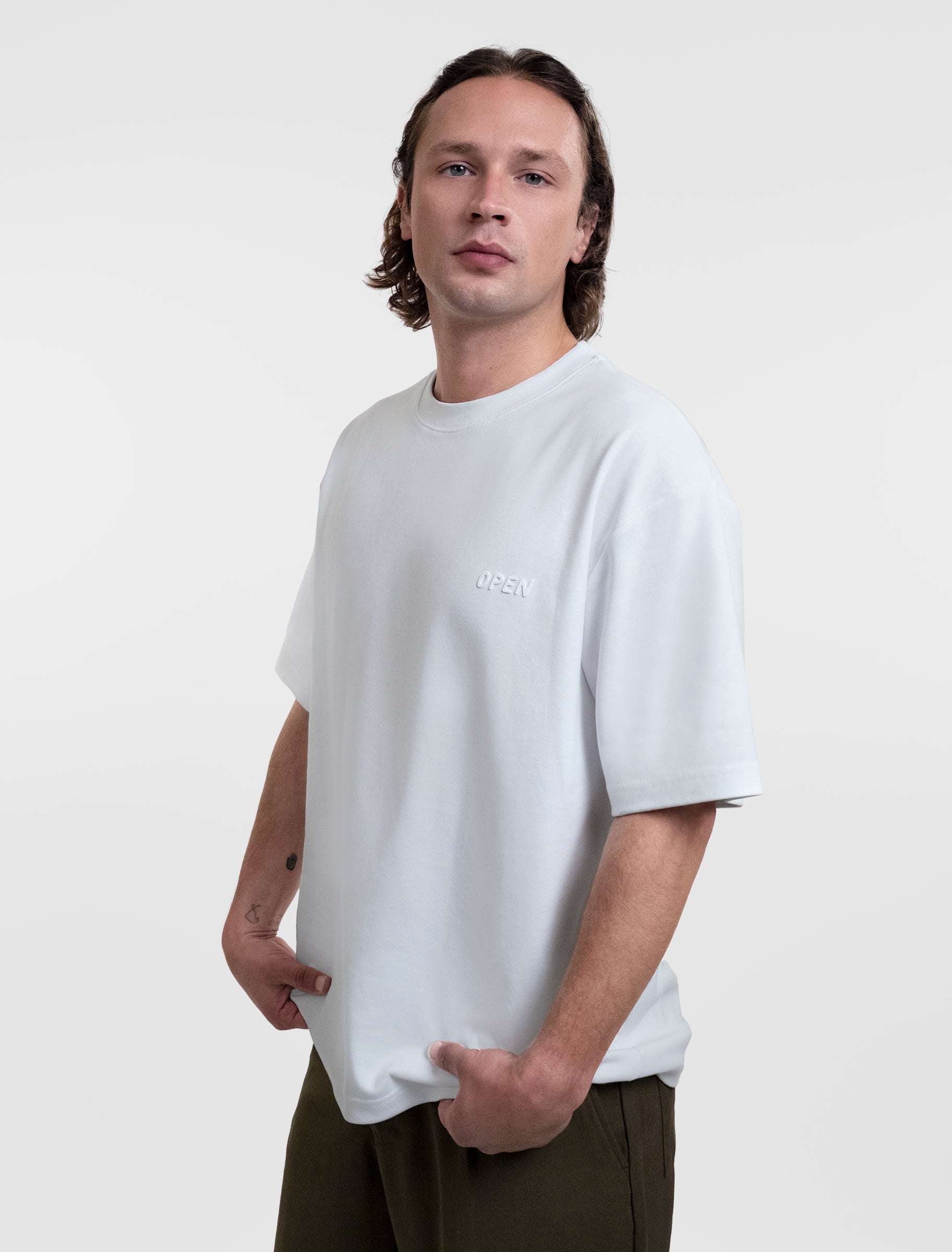 Open Row Men's Open Heart Tee in white, three-quarter front view.