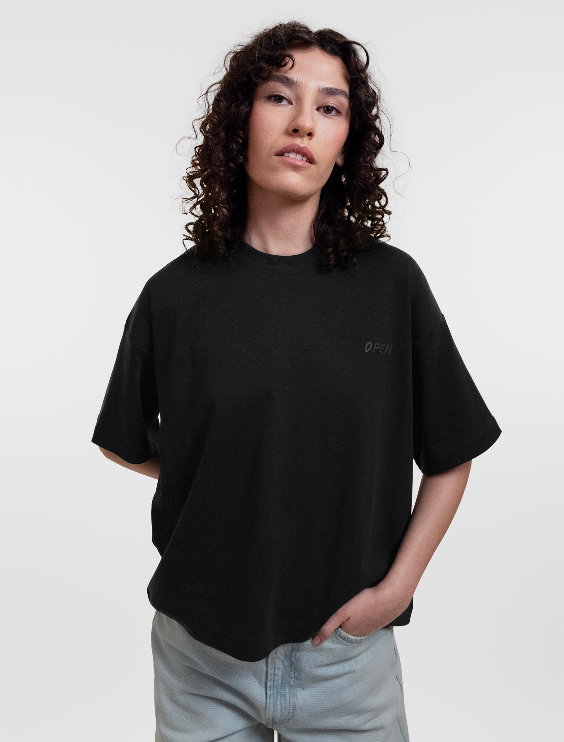 Open Row Women's Open Heart Tee in black, front editorial view.