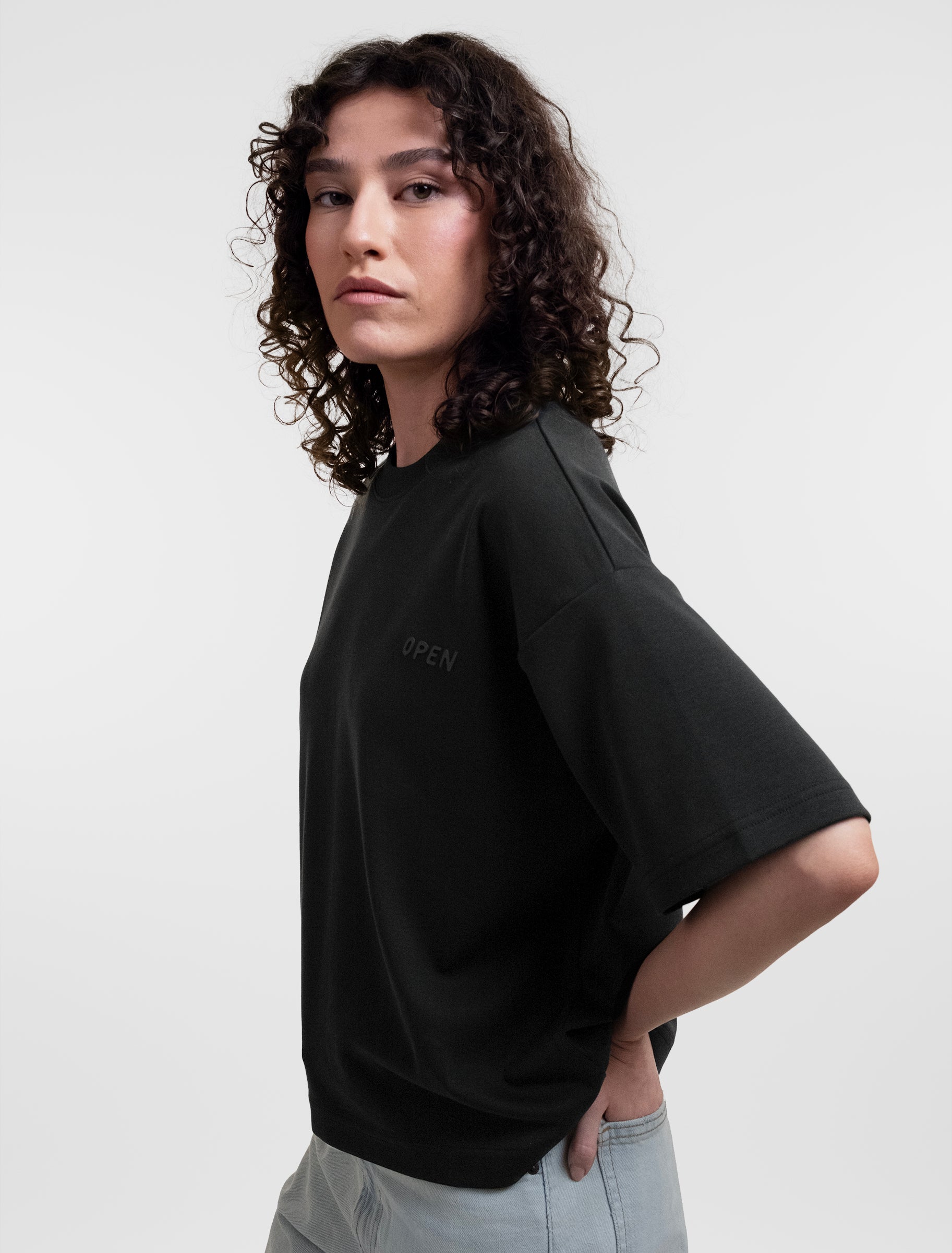 Open Row Women's Open Heart Tee in black, side view.