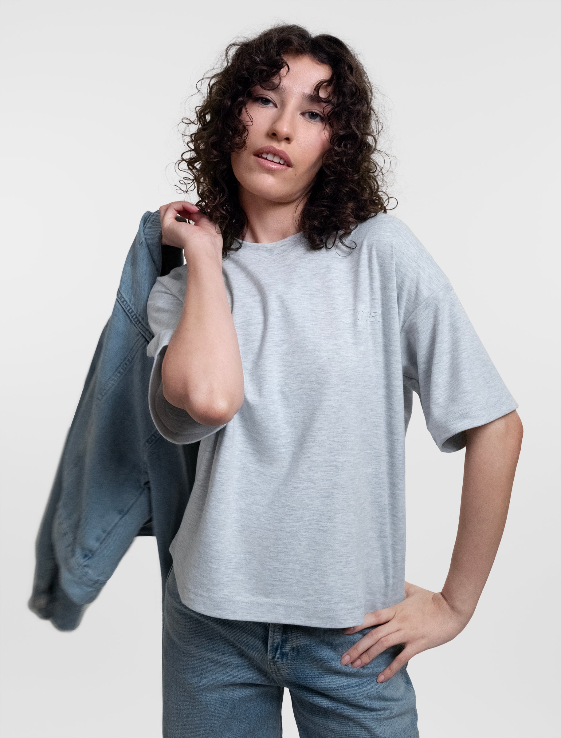Open Row Women's Open Heart Tee in grey, front editorial view paired with a denim jacket.