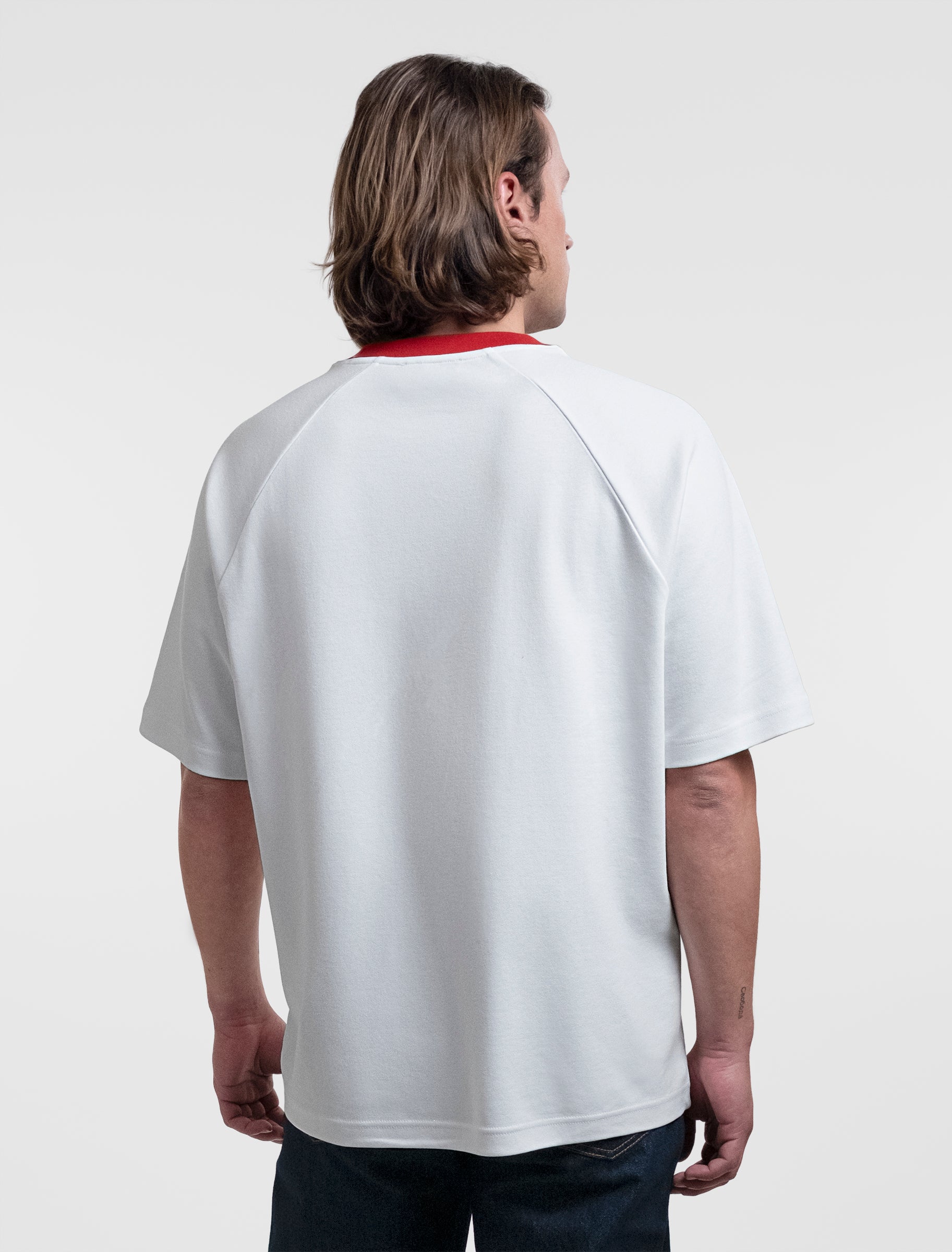 Open Row Men's Runaway Tee in white with red collar, back view.