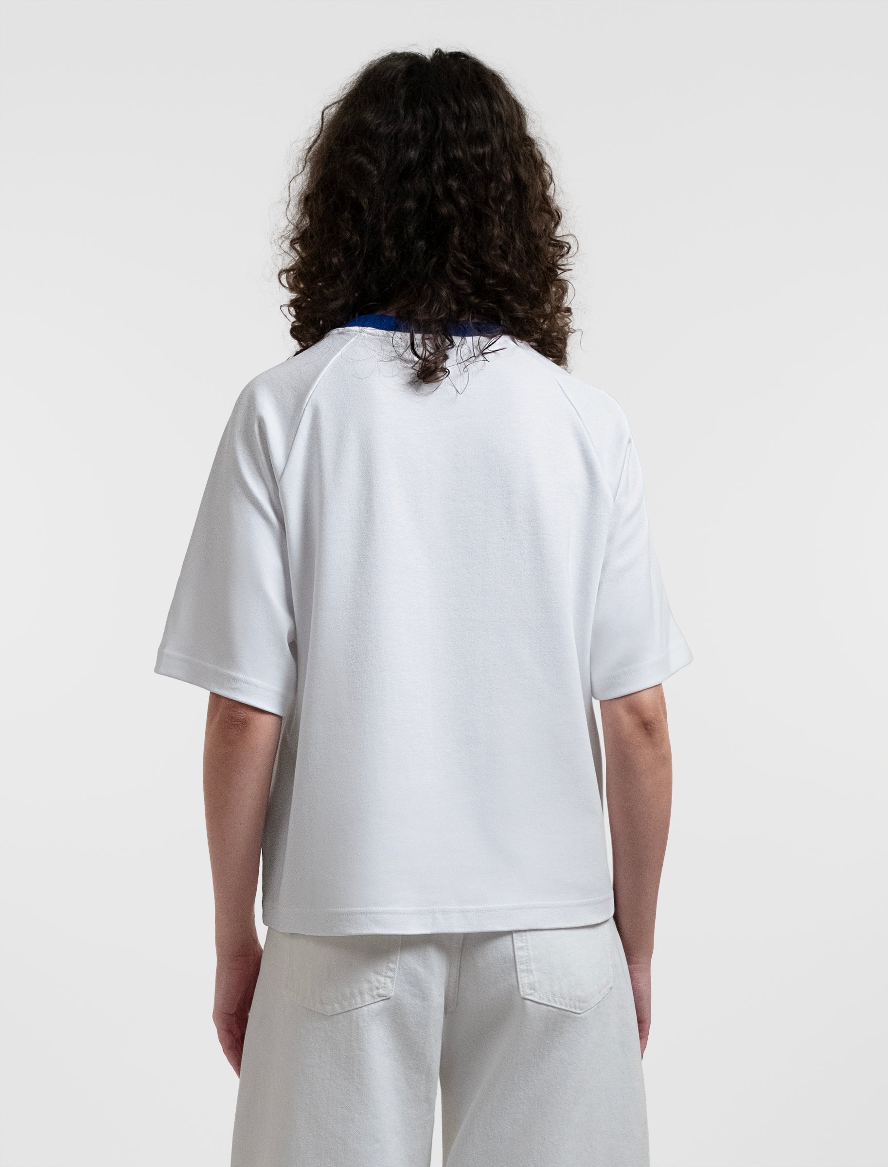 Open Row Women's Runaway Tee in white with blue collar, back view.