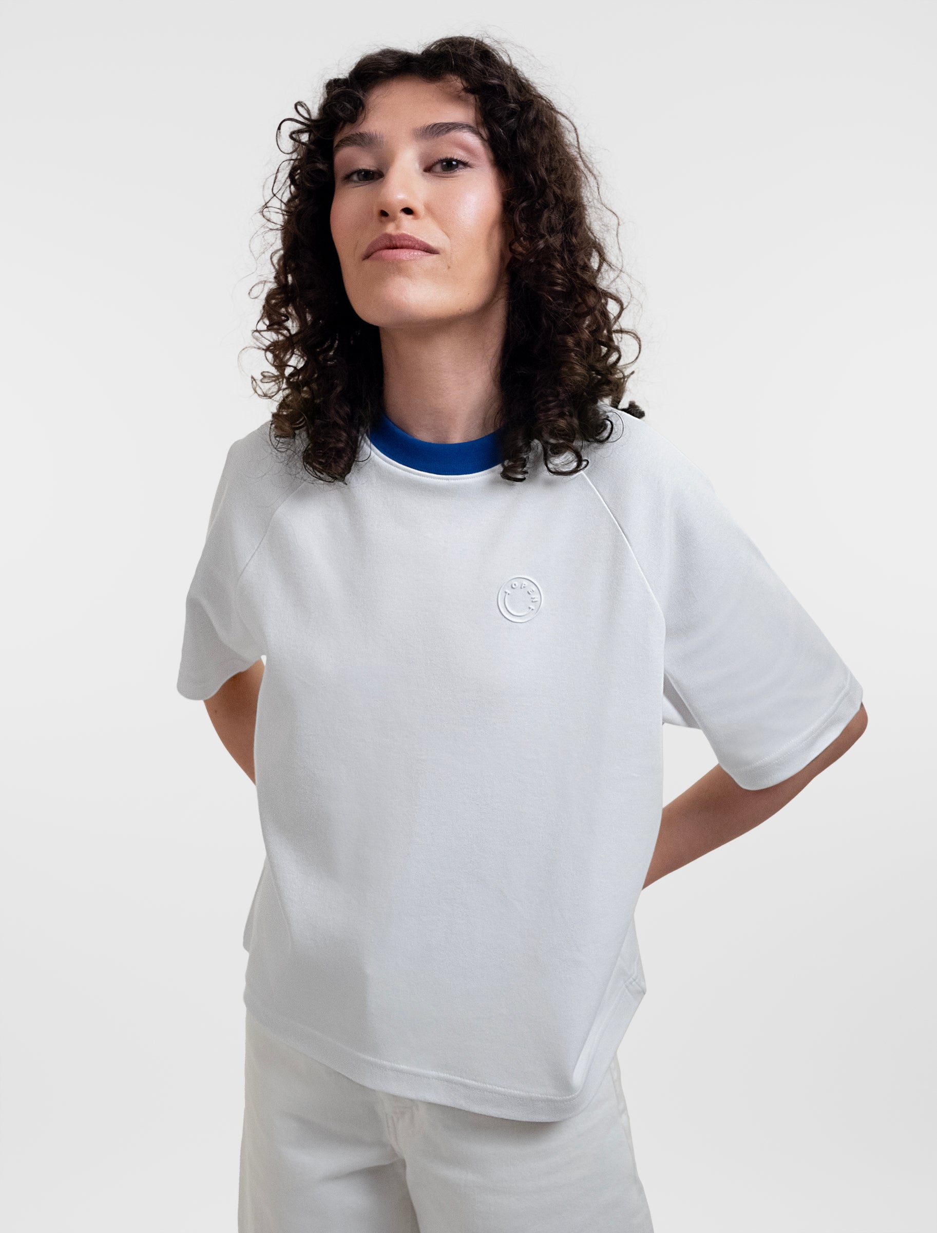 Open Row Women's Runaway Tee in white with blue collar, front editorial view.