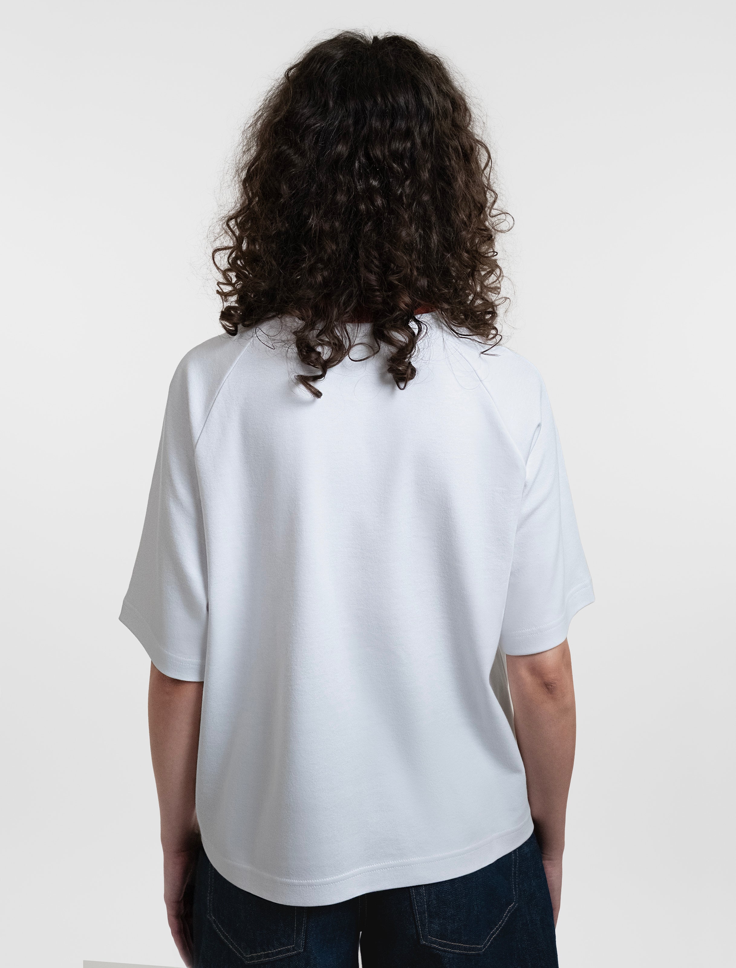 Open Row Women's Runaway Tee in white with red collar, back view.