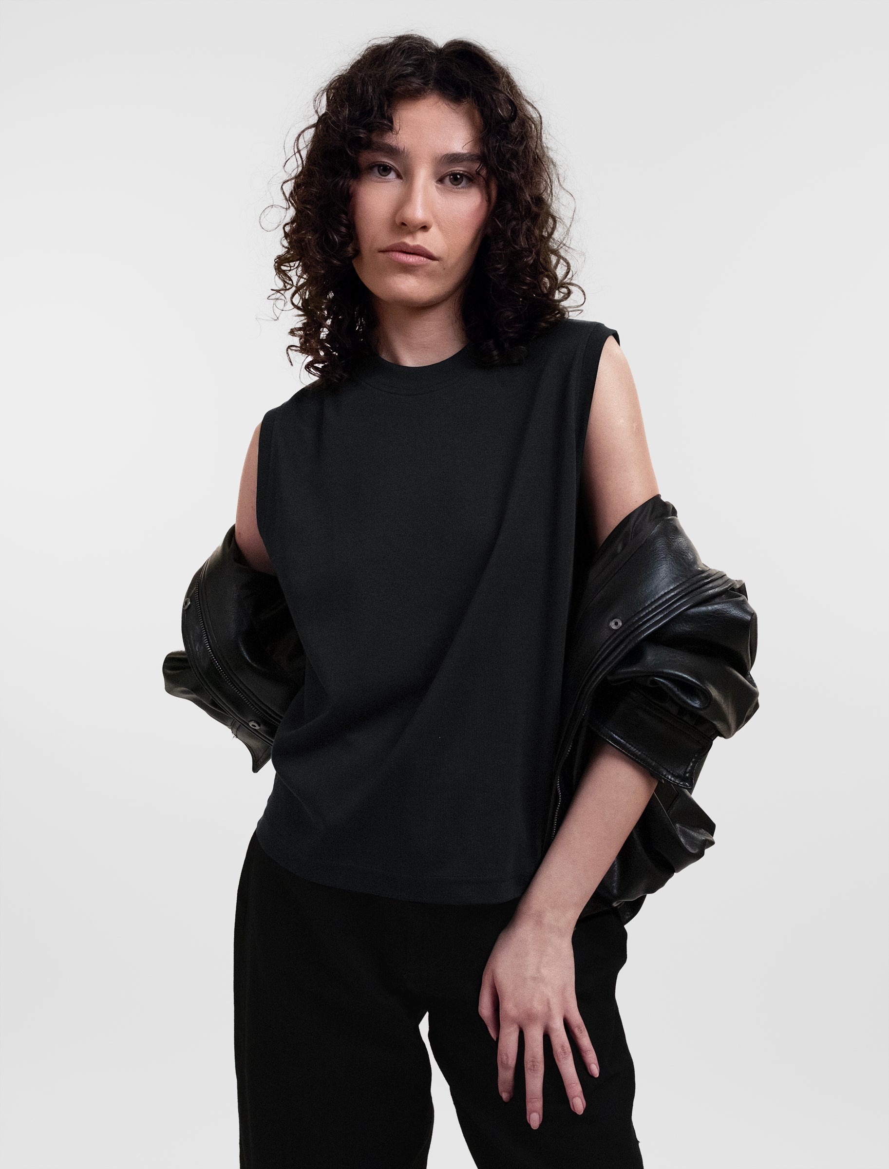 Open Row Women's Tank Tee in black, editorial view paired with a black leather jacket.